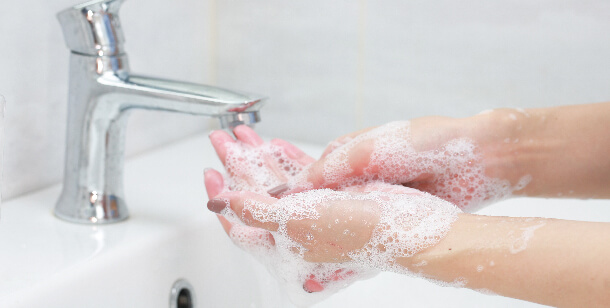 person washing hands in Houston, TX