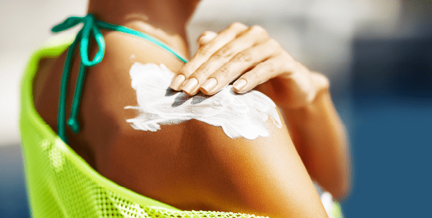 woman applying sunscreen