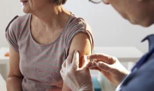 A women getting a pneumonia vaccine in Houston, TX