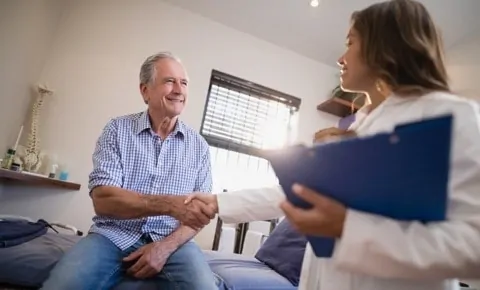 A male patient shakes hands with his doctor after visiting the emergency room in Houston, TX for pain management