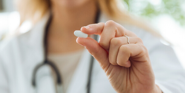 a doctor holds a pill at an emergency room in Houston, TX