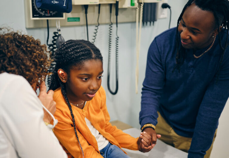 a girl getting her ears examined at an emergency room in Houston, TX