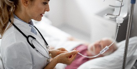 A doctor helps a patient with an IV in Houston, TX