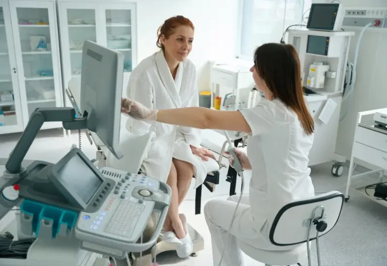 A woman speaks with her doctor after a transvaginal ultrasound in an emergency room in Houston, TX