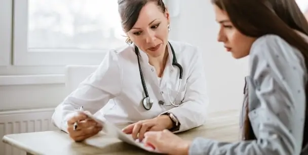 A physician and patient at an annual STD checkup in Houston, TX