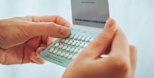 A woman holds birth control pills, a type of birth control, in Houston, TX