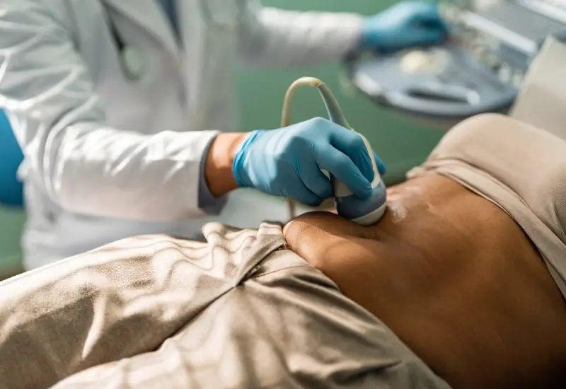 A woman undergoes an ultrasound of her abdomen in Houston, TX