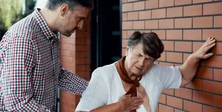 A woman leaning against a wall while having a stroke in Houston, TX